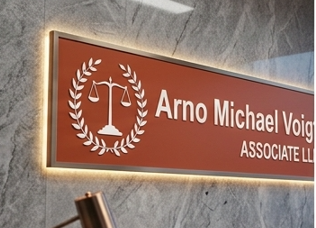 Illuminated Arno Michael Voigt Associate LLP sign in an office